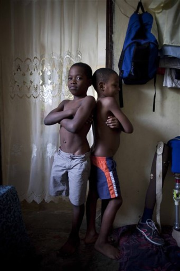 Sebastian Lamoth, 8, left, poses for a photo at his home with his cousin Joseph Rood in Port-au-Prince, Haiti, on Monday. Lamoth's leg was amputated due to an injury suffered in the Jan. 12, 2010 earthquake. Almost one year has passed since the magnitude-7.0 quake that killed more than 220,000 people and left millions homeless. 